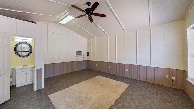 additional living space with a ceiling fan, an AC wall unit, and vaulted ceiling