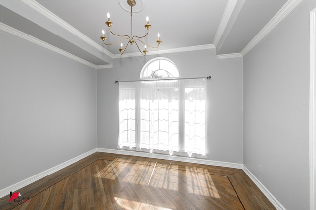 spare room with ornamental molding, wood finished floors, baseboards, and an inviting chandelier