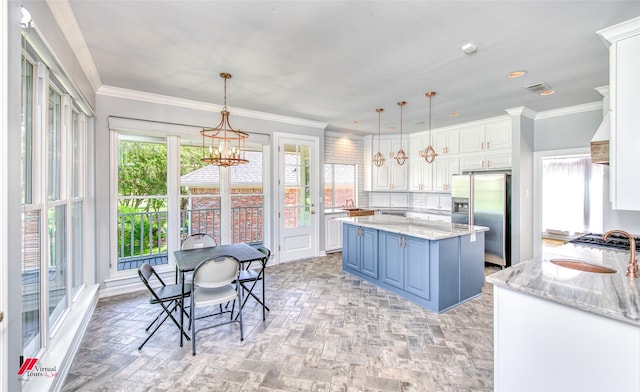 kitchen with light stone counters, decorative light fixtures, stainless steel refrigerator with ice dispenser, ornamental molding, and white cabinets