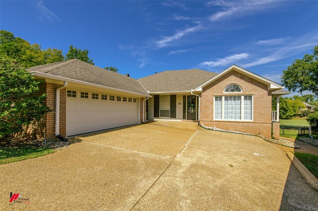 ranch-style home featuring a garage