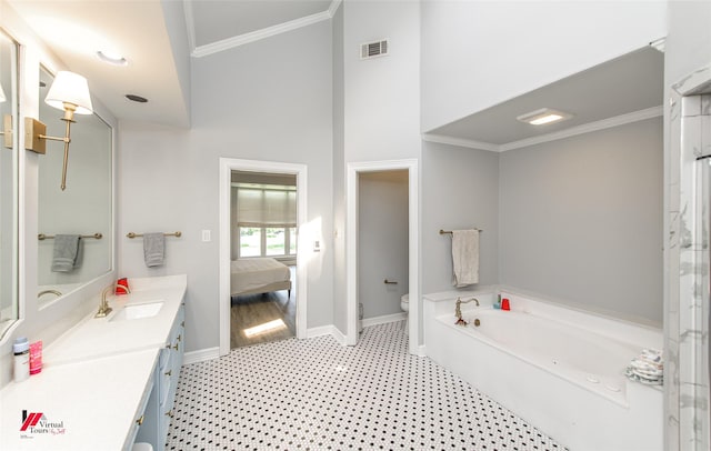 bathroom with ornamental molding, ensuite bath, vanity, and baseboards