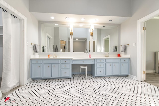 bathroom featuring double vanity, baseboards, tile patterned floors, a sink, and recessed lighting