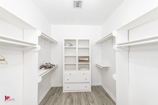 spacious closet with light wood-type flooring and visible vents