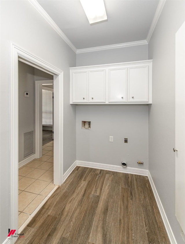 laundry area featuring cabinet space, visible vents, ornamental molding, hookup for a washing machine, and hookup for an electric dryer