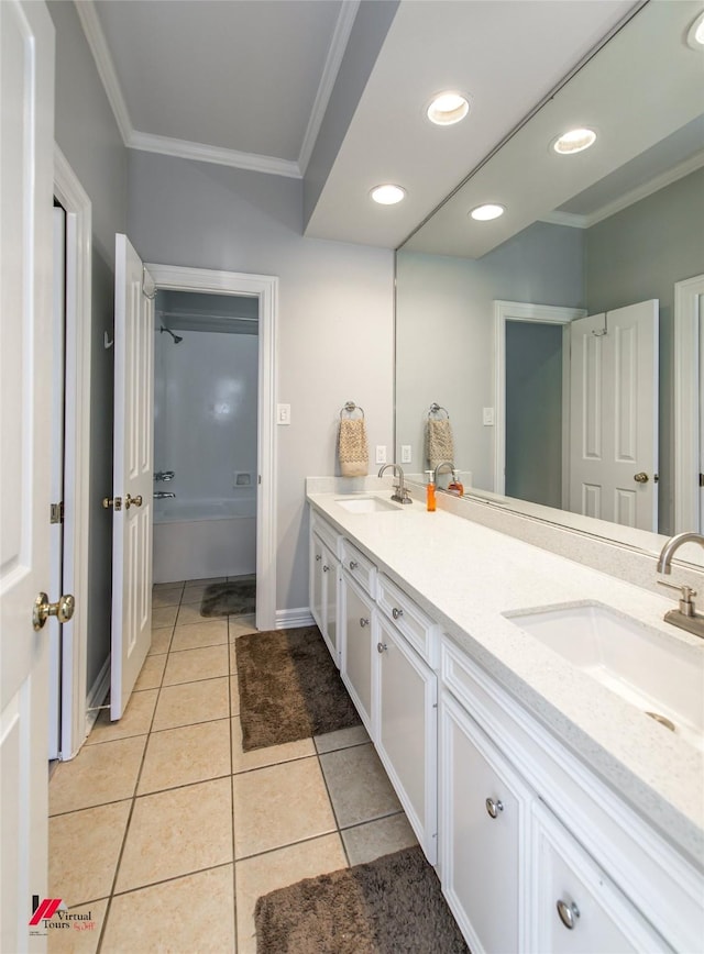 bathroom with double vanity, tile patterned floors, a sink, and crown molding