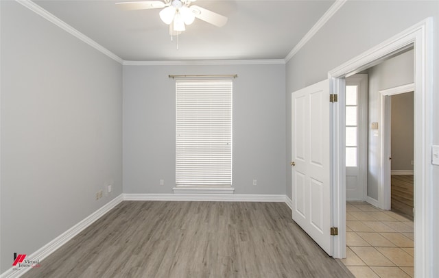 empty room with light wood finished floors, ceiling fan, baseboards, and crown molding