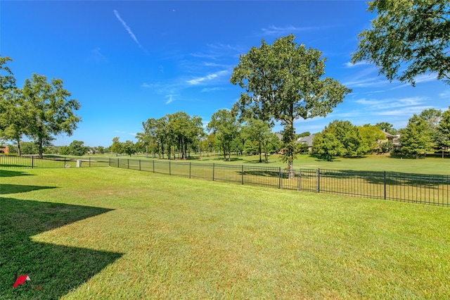 view of yard with fence and a rural view