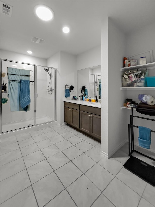 bathroom with a shower stall, visible vents, tile patterned flooring, and vanity