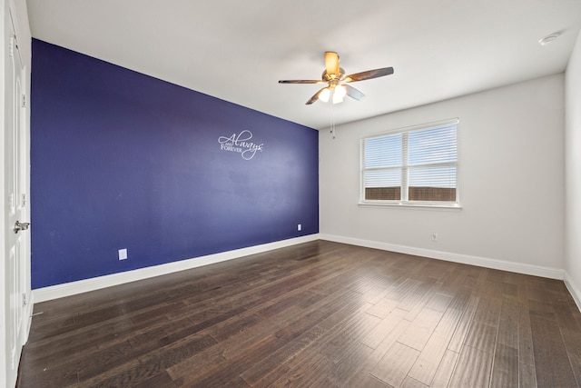 spare room featuring dark hardwood / wood-style flooring and ceiling fan