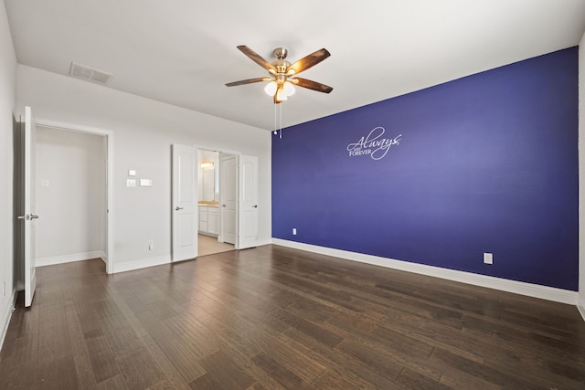 unfurnished bedroom with dark wood-type flooring, ceiling fan, and ensuite bathroom