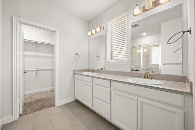 bathroom with vanity, an enclosed shower, and tile patterned floors