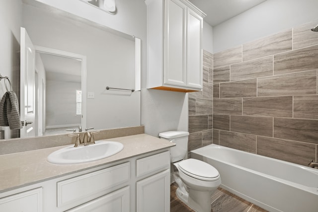 full bathroom featuring tiled shower / bath combo, toilet, hardwood / wood-style flooring, and vanity