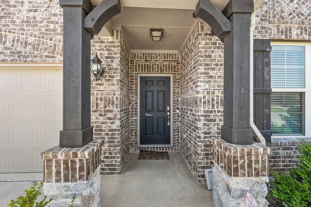 view of exterior entry with a garage