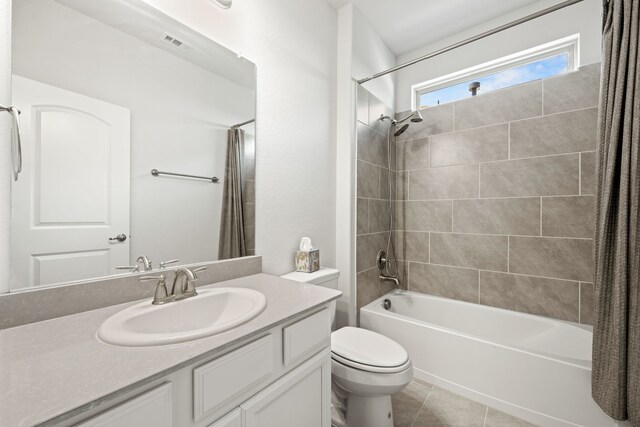 full bathroom with tile patterned flooring, vanity, toilet, and shower / tub combo