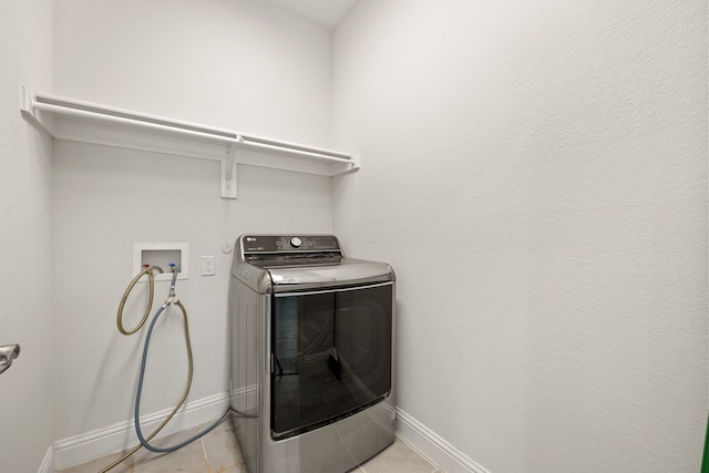 laundry room featuring washer / dryer and light tile patterned floors