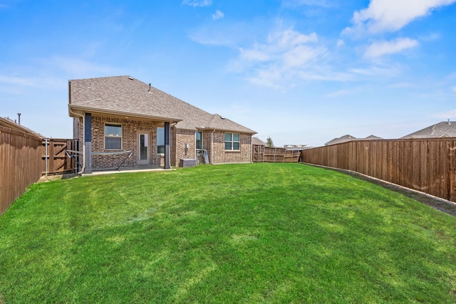 rear view of house featuring a yard