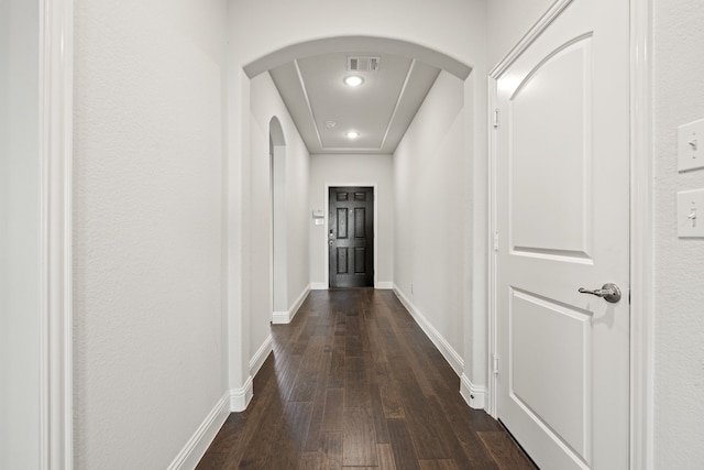 hallway with dark hardwood / wood-style flooring