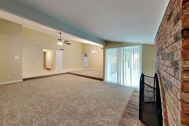 unfurnished living room with light carpet, vaulted ceiling, a brick fireplace, and ceiling fan with notable chandelier