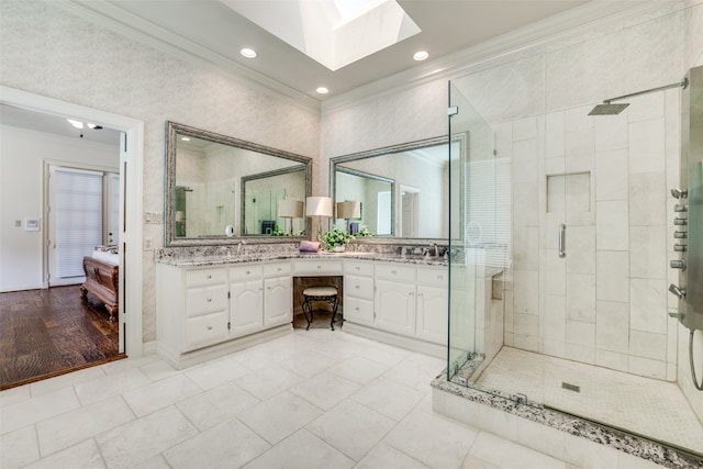 bathroom with vanity, an enclosed shower, ornamental molding, and a skylight