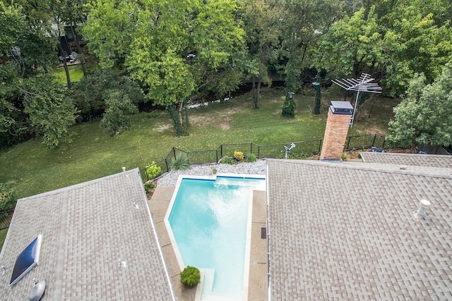 view of pool featuring a lawn