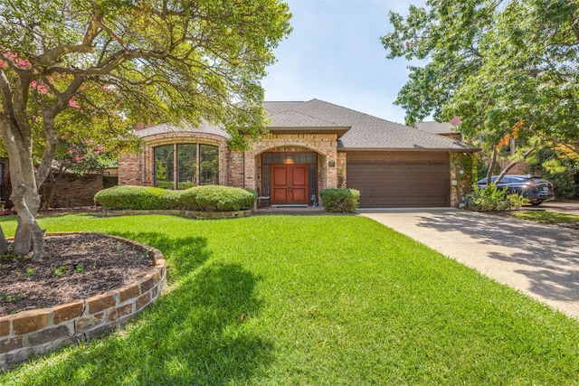 view of front of home featuring a garage and a front lawn