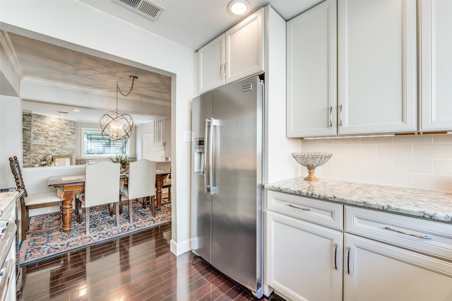 kitchen with light stone counters, dark hardwood / wood-style floors, tasteful backsplash, high end fridge, and white cabinets