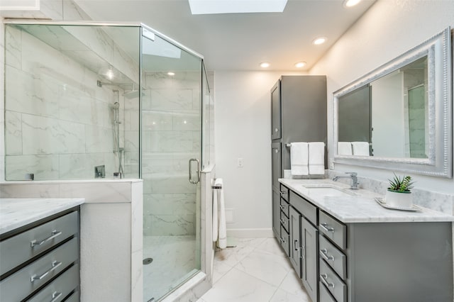 bathroom with a shower with shower door, tile patterned flooring, a skylight, and vanity