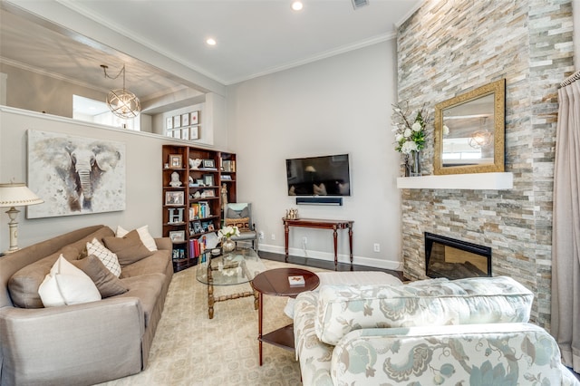 living room with a towering ceiling, crown molding, and a fireplace