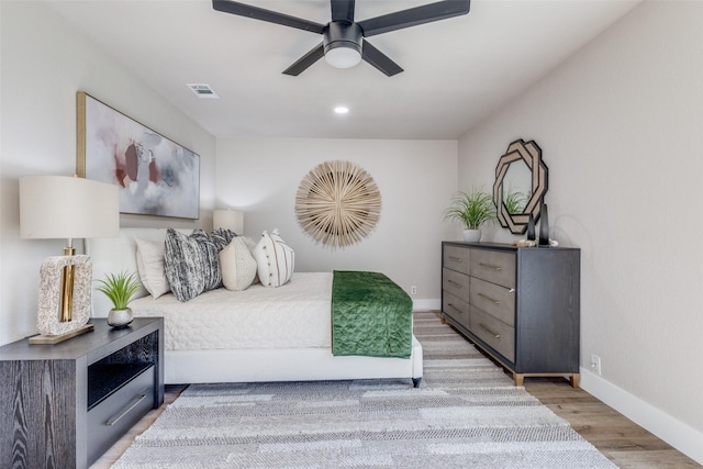 bedroom with ceiling fan and light hardwood / wood-style floors