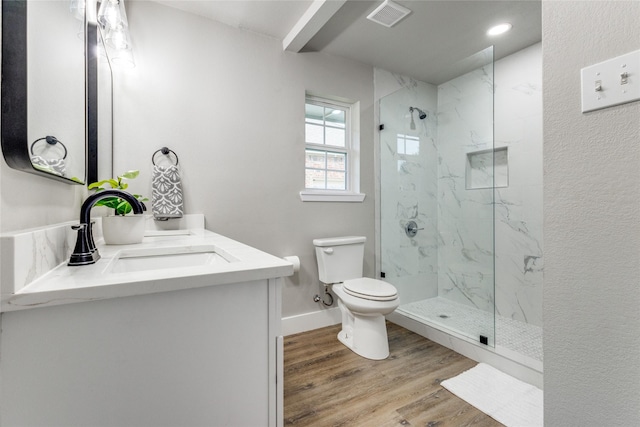 bathroom with toilet, a shower with door, vanity, and hardwood / wood-style floors