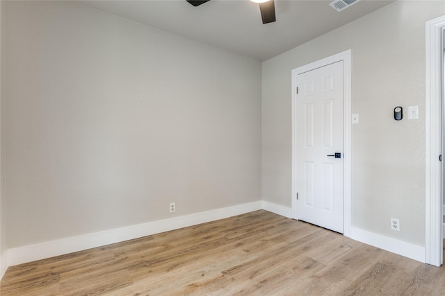 spare room featuring light hardwood / wood-style floors and ceiling fan