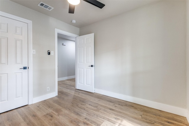 unfurnished bedroom with ceiling fan and light hardwood / wood-style floors