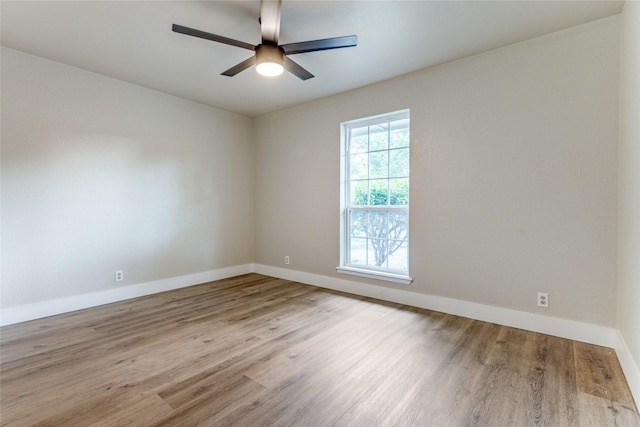 spare room with ceiling fan and light wood-type flooring