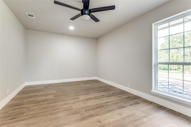 empty room featuring ceiling fan and light hardwood / wood-style floors