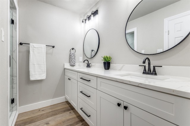 bathroom with vanity, hardwood / wood-style flooring, and walk in shower