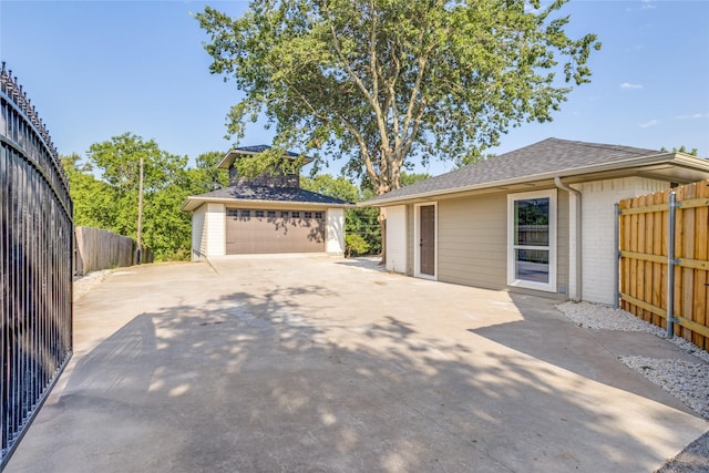 view of home's exterior featuring a garage and an outdoor structure