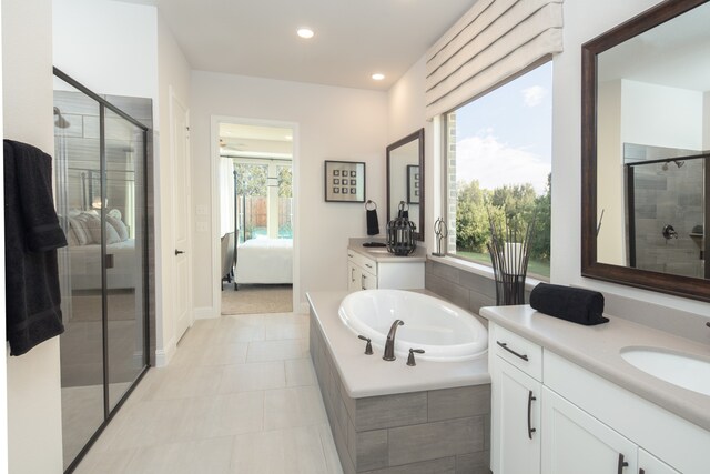 bathroom featuring vanity, shower with separate bathtub, and tile patterned flooring