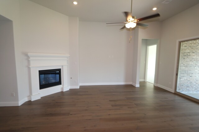 unfurnished living room with ceiling fan and dark hardwood / wood-style flooring