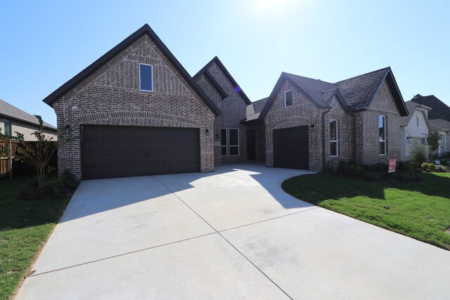 view of front of property with a front lawn and a garage