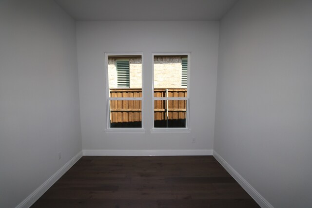 spare room with dark hardwood / wood-style flooring