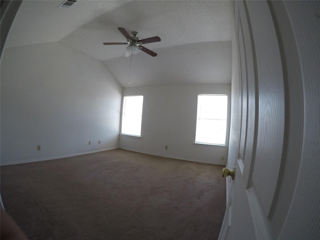 unfurnished room with lofted ceiling, ceiling fan, and carpet flooring