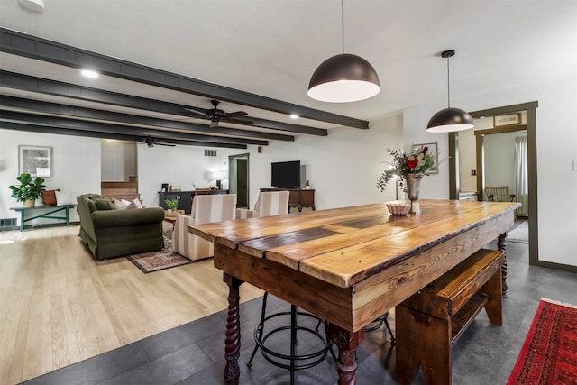 dining space with ceiling fan, beam ceiling, and hardwood / wood-style flooring