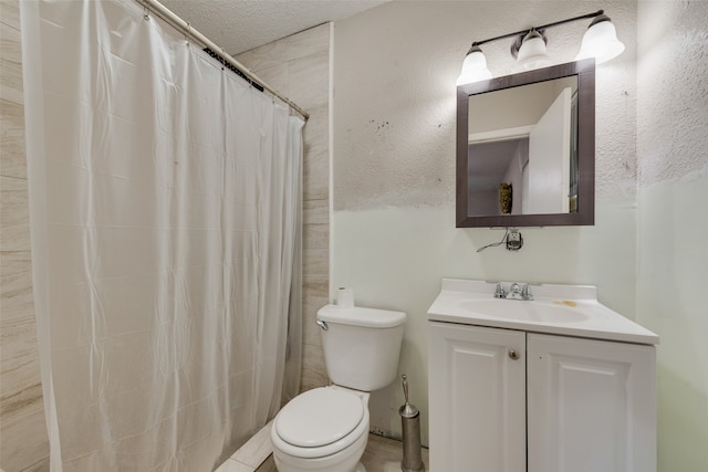 bathroom featuring vanity, toilet, a textured ceiling, and curtained shower