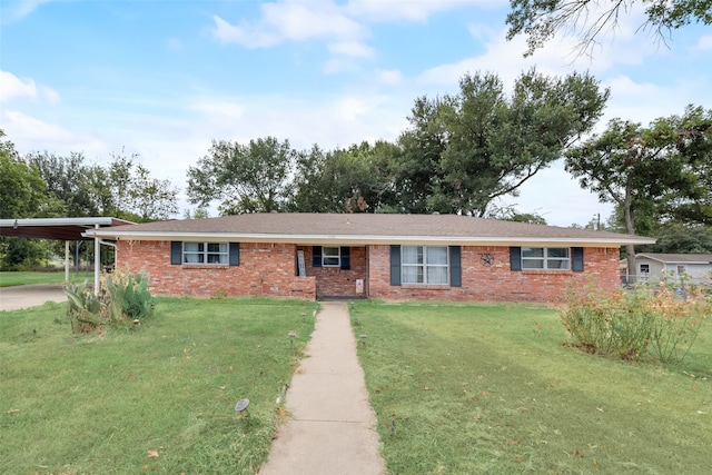 ranch-style home featuring a front lawn and a carport