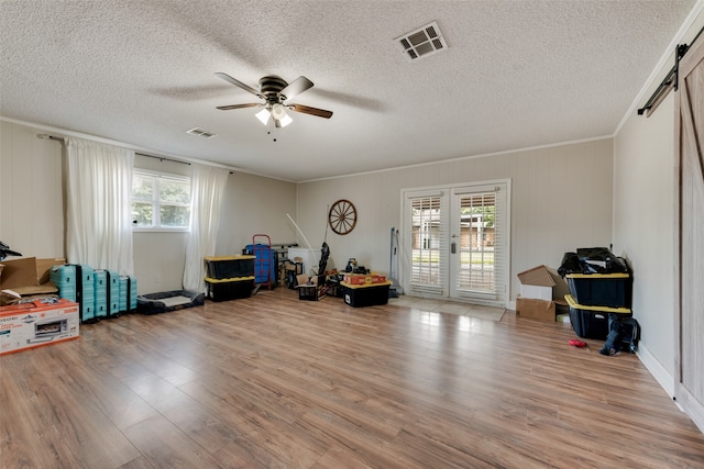 misc room with ceiling fan, plenty of natural light, and light hardwood / wood-style floors