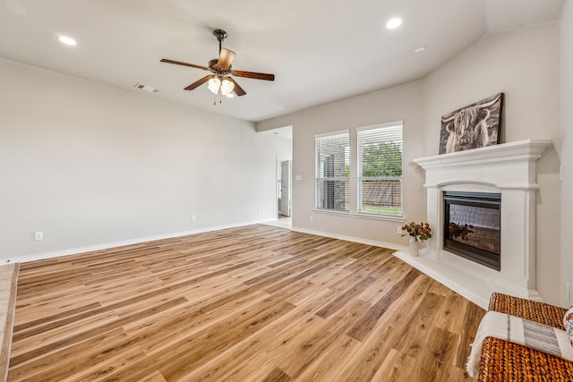 unfurnished living room featuring ceiling fan and light wood-type flooring