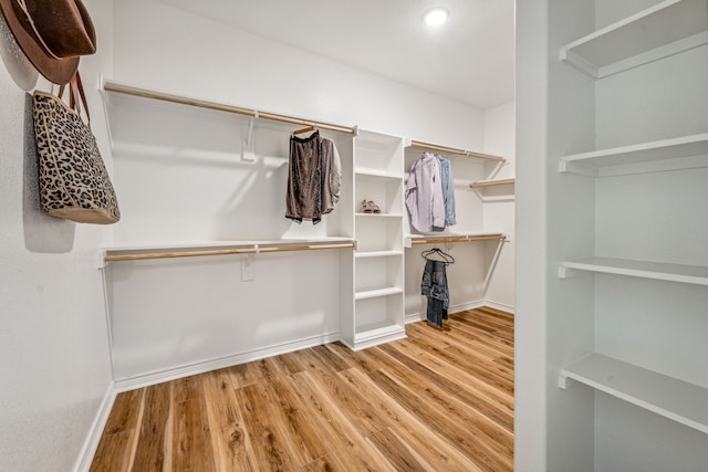 spacious closet with light hardwood / wood-style flooring