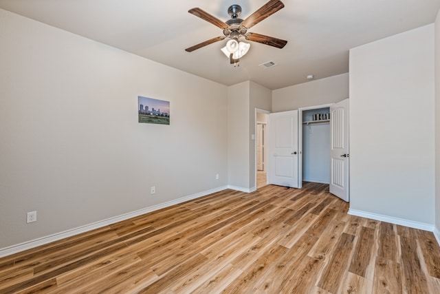 unfurnished bedroom with ceiling fan, a closet, and light hardwood / wood-style flooring