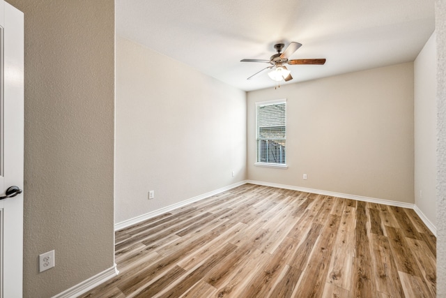 unfurnished room featuring ceiling fan and hardwood / wood-style floors