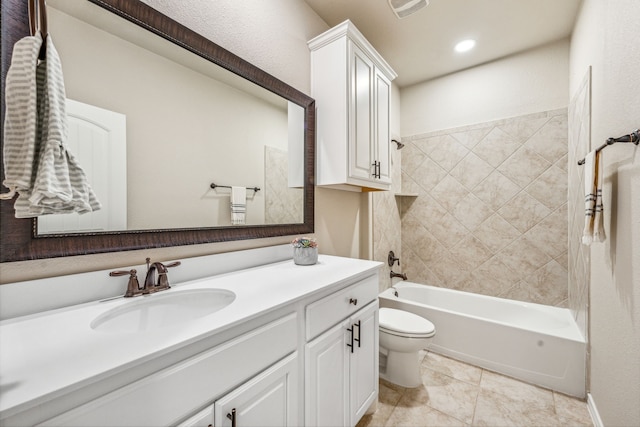 full bathroom featuring tile patterned floors, vanity, tiled shower / bath combo, and toilet